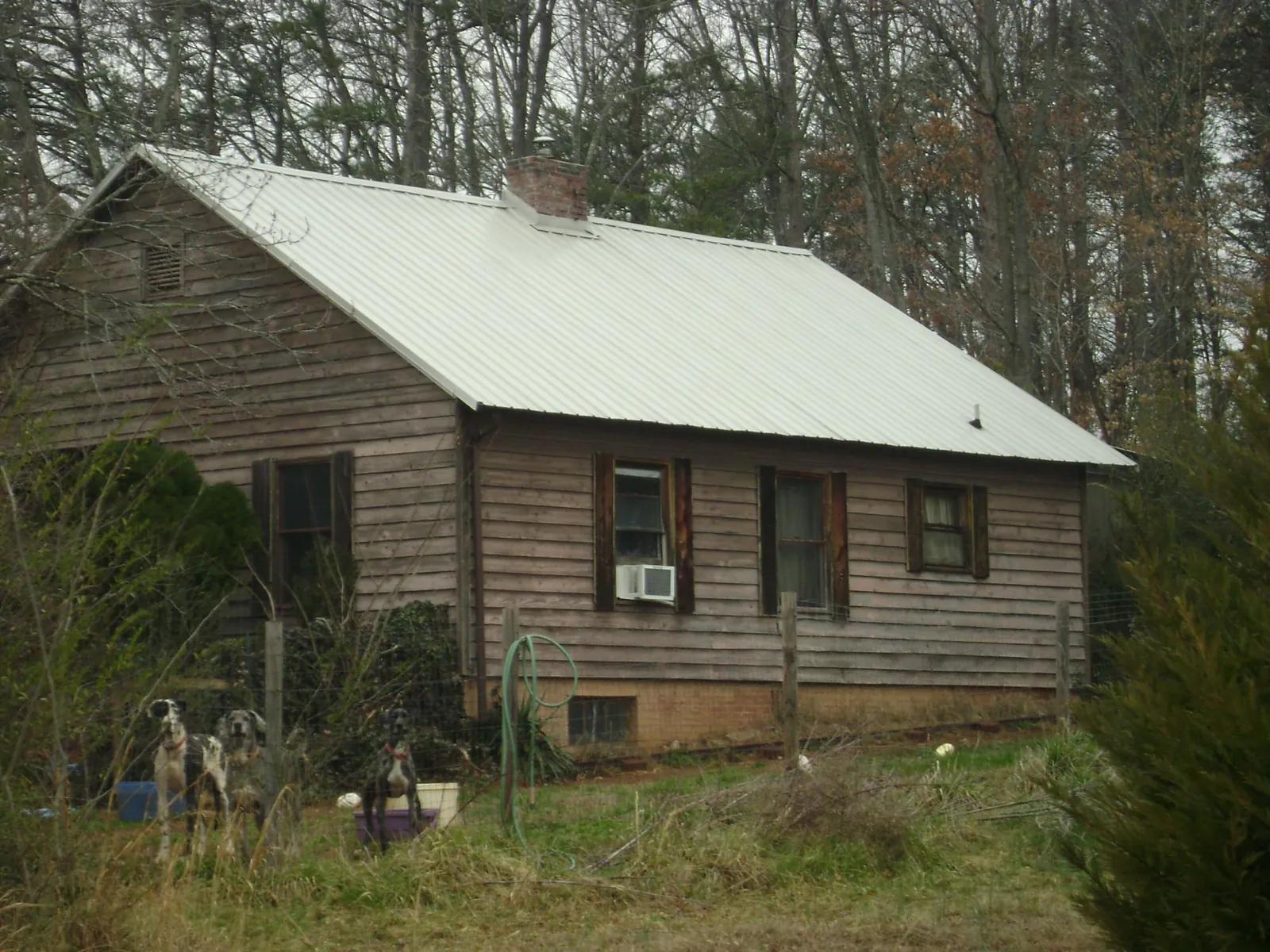 White metal roof on an old wood sided farmhouse, from a Metal Roof Installation job in Marcy